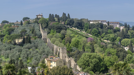 Beautiful aerial view of the ancient walls of Florence, Italy, surrounded by beautiful gardens on a sunny day