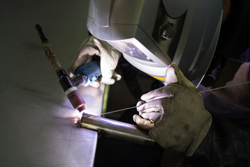 Closeup of man wearing mask welding in a workshop