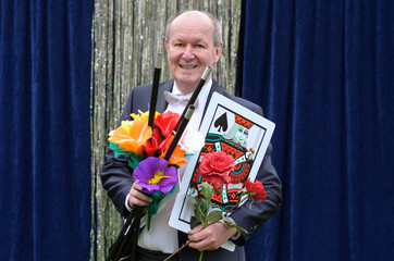 Smiling friendly magician carrying his props