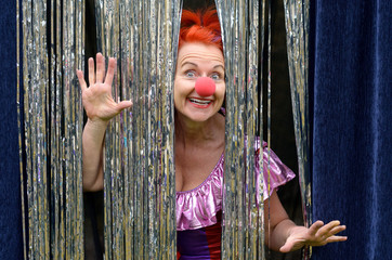 Fun loving woman in a red clown nose
