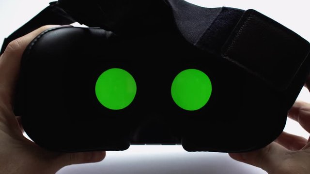 Mans hands take vr glasses and wear them. Virtual reality headset. 4k UHD video