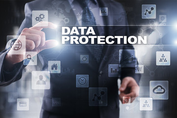 Businessman selecting data protection on virtual screen.