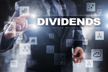 Businessman selecting dividends on virtual screen.