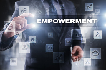 Businessman selecting empowerment on virtual screen.