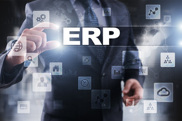 Businessman selecting erp on virtual screen.
