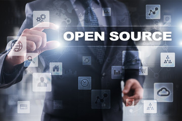 Businessman selecting open source on virtual screen.