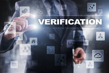 Businessman selecting verification on virtual screen.