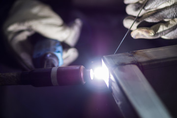 Closeup of man wearing mask welding in a workshop