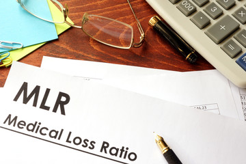 Document with title Medical Loss Ratio (MLR) in an office. 