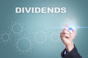 Businessman drawing on virtual screen. dividends concept