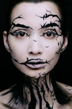 beautiful woman with creative make-up halloween tree make-up
