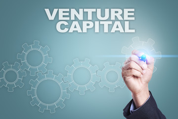 Businessman drawing on virtual screen. venture capital concept