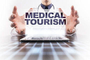 Medical doctor using tablet PC with medical tourism medical concept.
