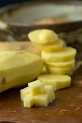 Potatoes and potato sliced on wooden table. Selective focus