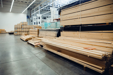 sawn wood. Shelf with structural materials on the shelves in the construction warehouse.