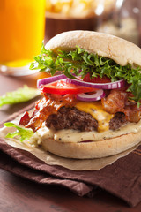bacon cheese burger with beef patty, tomato and onion beer