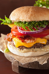 bacon cheese burger with beef patty, tomato and onion