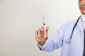 Doctor with syringe is preparing for medical injection