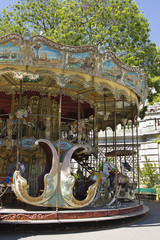 Carousel in city park. Summer.