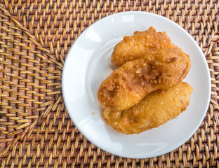 Fried banana on white dish