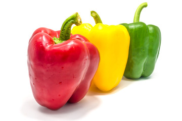 Yellow green and red bell peper on white background.