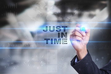 Businessman is drawing on virtual screen. just in time concept.