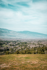Lanscape of trees and we can see the sky blue next to the mountain