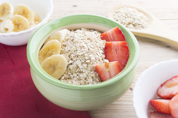 Bowl oats ingredients (oat, banana, strawberry and vegetal milk)