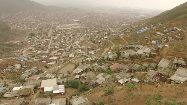 Aerial of Slums in Lima, Peru. Flying over houses.