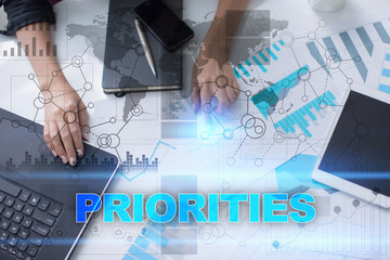 Woman working with documents, tablet pc and notebook and selecting priorities.