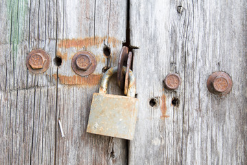 Old rusty lock hanging on the shed