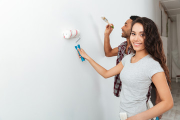 Portrait of woman painting wall