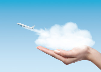 Woman holding cloud with plane taking off