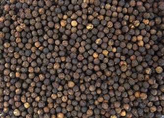Black peppercorns background. Isolated.