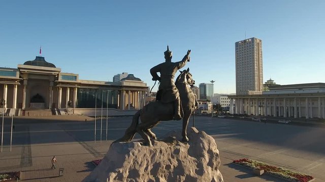 Grand Chinggis Khaan S&uuml;khbaatar central capital Ulaanbaatar Square. Colonnade monument statue. Government Palace Statue megalopolis. Morning sun warm sunrise long shadows