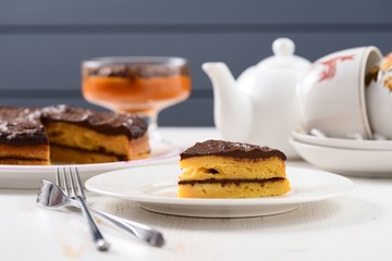 White faience teaware, homemade low callorie pumpkin dessert and layered pumpkin cake with chocolate icing