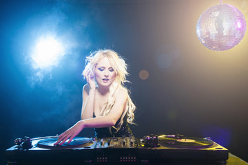 Beautiful DJ girl on decks 