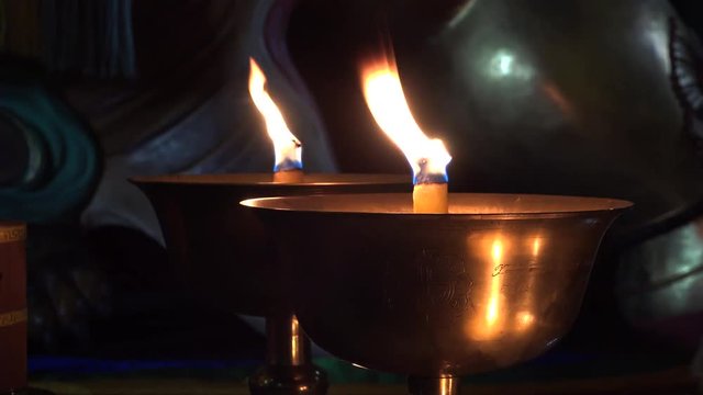 Cinematic candle fire light Gandan Gandantegchinlen Chinese-style Tibetan Buddhist Monastery. Center of Mongolian capital of Ulaanbaatar. Religion world famous attraction.