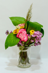 The composition of a bouquet of flowers is in a transparent vase