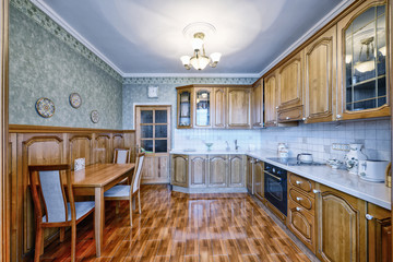 The kitchen is solid wood in a classic style in a modern house.