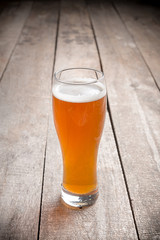 glass beer on wood background