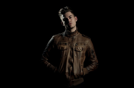Handsome man posing in brown, leather jacket