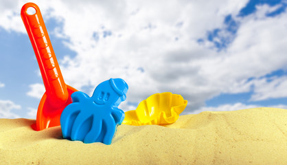 Fototapeta na wymiar Plastic children toys on the sand beach