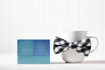 Mug with bowtie and blue wooden blocks