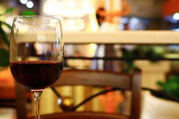 Serving a glass of red wine in a restaurant