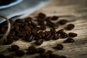 Coffee cup and beans on a wooden table.