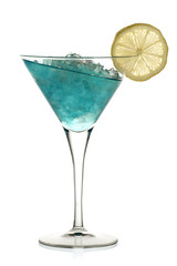 Blue alcoholic cocktail with leaning liquid and a lemon 