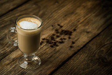 Coffee cup and coffee beans on table