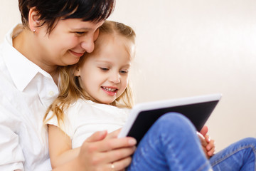 Mom and daughter using tablet Mother and daughter using tablet computer together