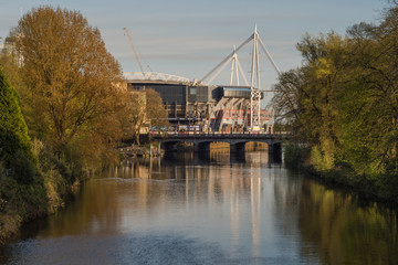 Millennium Stadium and River Taff from Bute Park. National stadium of Wales in evening light in Cardiff, UK